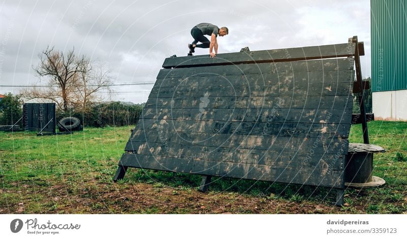 Man in obstacle course climbing pyramid Sports Climbing Mountaineering Human being Adults Authentic Strong Loneliness Effort Competition obstacle course race