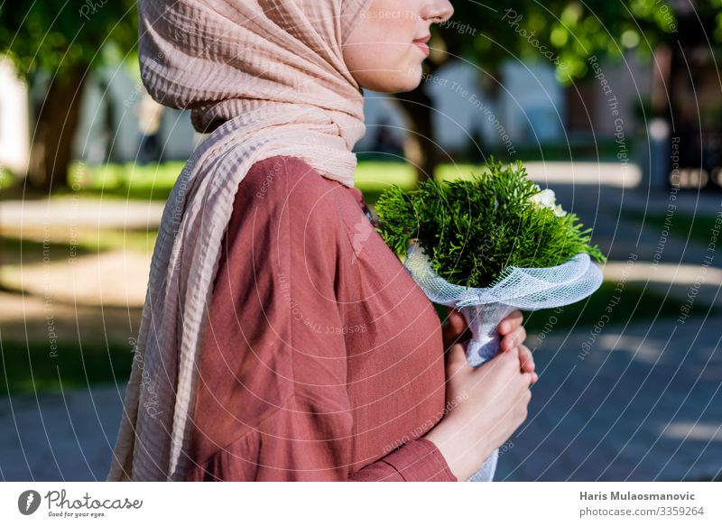 Muslim girl wearing hijab with flowers elegance Lifestyle Elegant Joy Human being Feminine Young woman Youth (Young adults) Body Chest Hand 1 18 - 30 years