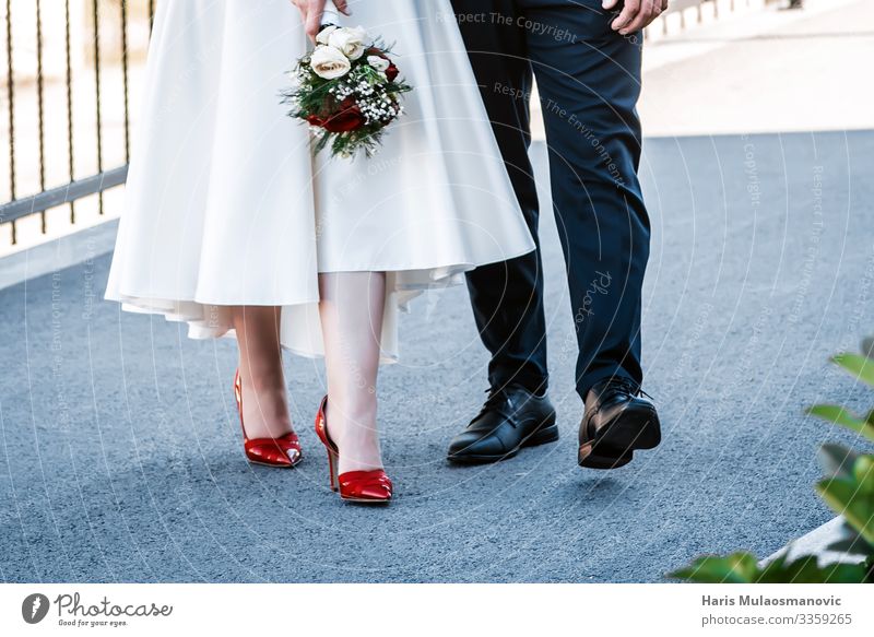 wedding couple walking feet close up with bouquet Life Legs Walking Near Love Lovers Footwear Leather White Dress Bouquet Colour photo Exterior shot