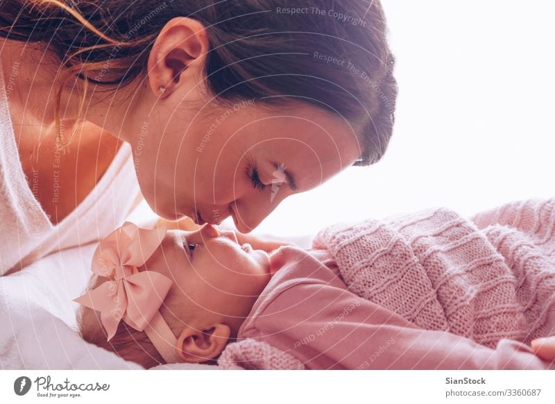 Young mother kissing her adorable baby girl. Joy Happy Beautiful Playing Child Baby Woman Adults Parents Mother Family & Relations Infancy Kissing Smiling Love