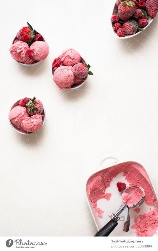 Berries ice cream in bowls with frozen fruits on white table Food Dairy Products Fruit Cake Dessert Ice cream Candy Bowl Cool (slang) Fresh Delicious above view