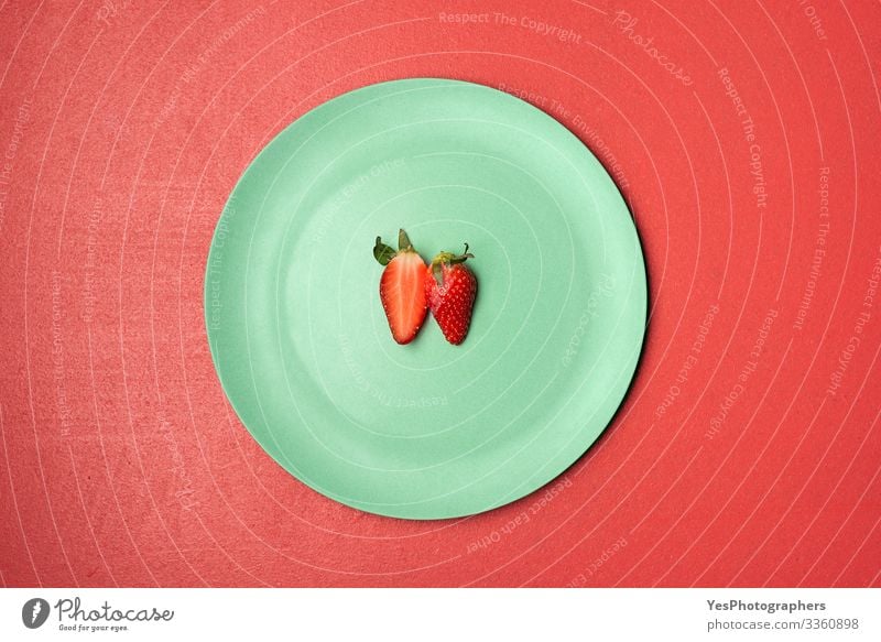 One strawberry cut in half on green plate Food Fruit Dessert Candy Nutrition Breakfast Organic produce Plate Delicious Natural above view Berries