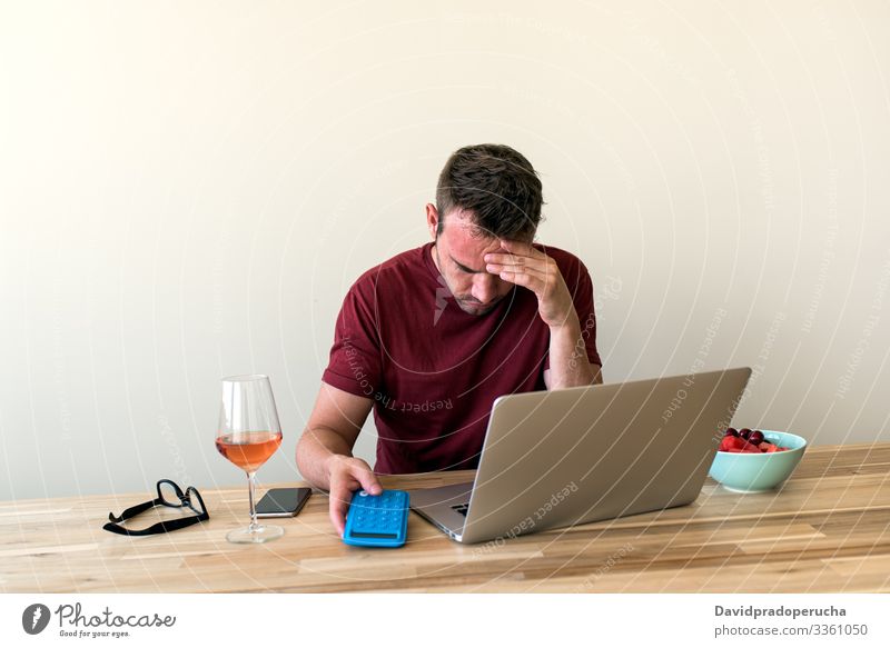 ale freelancer using laptop at home man kitchen relax table wine chill surfing browsing weekend alcohol alone beverage refreshment remote dining room