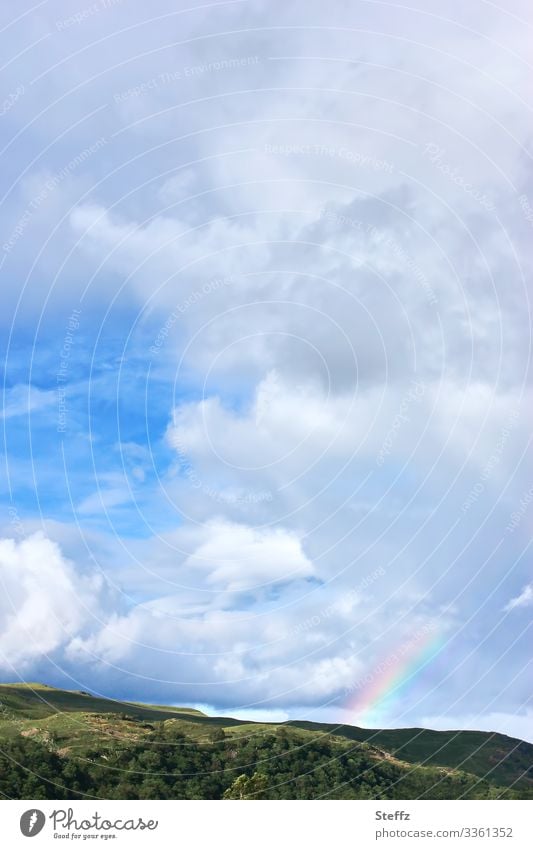 Rainbow between heaven and earth Prismatic colors Scotland Blue sky sky image Sky Nordic certain light Nordic romanticism celestial sign Scottish Hill