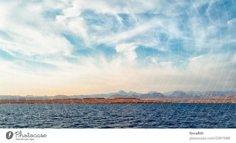 rocky coast of the Red Sea andblue sky with clouds Exotic Vacation & Travel Tourism Trip Summer Ocean Nature Landscape Sand Sky Clouds Horizon Climate Rock