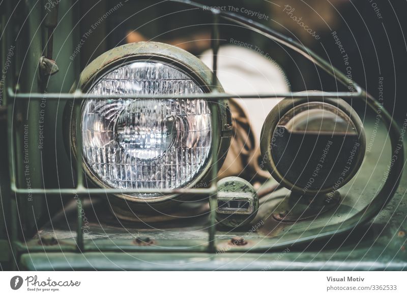 Left front lamp of a WWII GMC 352 Design Lamp Transport Vehicle Metal Steel Old Strong Green Colour interior metallic structure chassis powerful rim left
