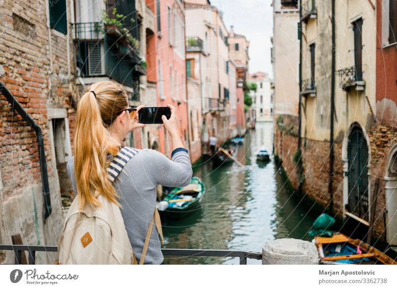 Young woman taking a photo of a canal in Venice Lifestyle Vacation & Travel Tourism Trip Sightseeing City trip Cellphone Human being Feminine