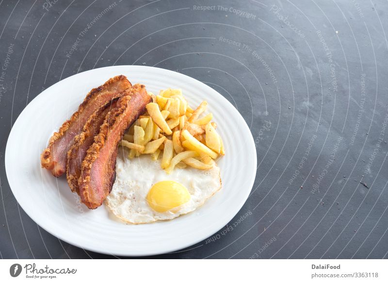 Typical spanish breakfast Torrezno, potatoes chips and egg typical torrezno