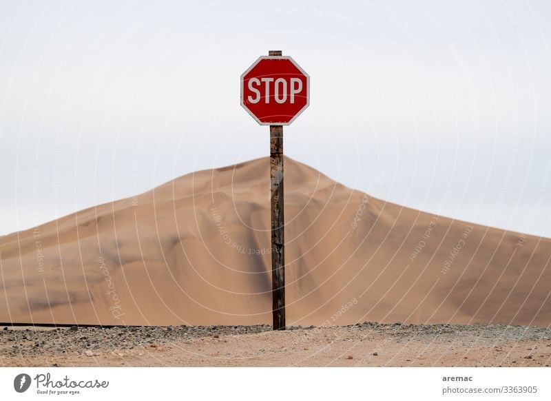 Stop sign in front of a huge sand hill the desert in Namibia Sign Traffic Desert Sand Hill Africa Loneliness Dry Vacation & Travel Nature Colour photo Deserted