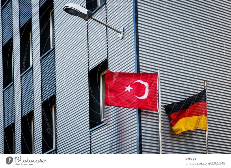 Germany flag and Turkey flag flying together in the wind in front of a building Turkish flag German flag German Flag High-rise Mosque Integration