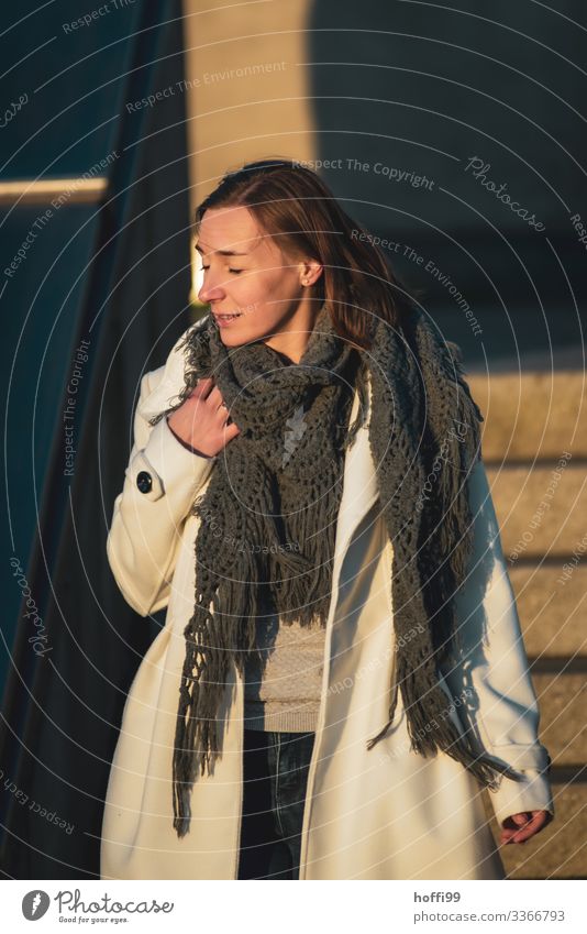 young woman in a coat at sunrise Lifestyle Style luck Young woman Youth (Young adults) 1 Human being 18 - 30 years Adults Coat peel brunette Long-haired Part