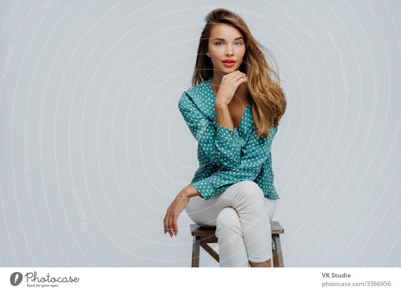 Indoor shot of lovely woman sits on chair Style Skin Face Make-up Contentment Chair Human being Feminine Woman Adults Clothing Sit Fresh Long Natural