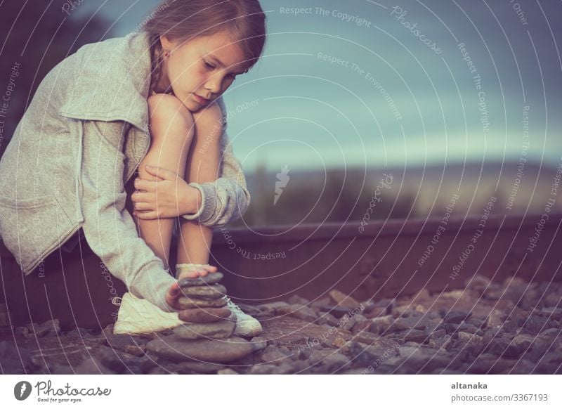 Portrait of young sad girl sitting outdoors on the railway at the day time. Concept of sorrow. Face Child Human being Woman Adults Family & Relations Infancy