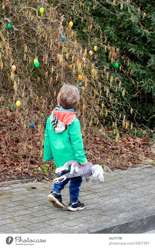 Easter walk II Child Boy (child) 1 Human being 3 - 8 years Infancy Plant Bushes Hazelnut Movement Looking Curiosity Multicoloured Easter egg Exterior shot