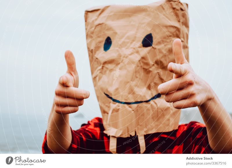 Person with paper bag on head pointing at camera plastic package ecology concept environment person gesture sign nature pollution problem packet polyethylene