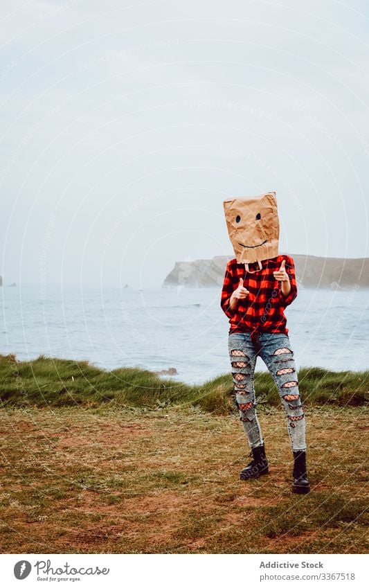 Person with paper bag on head pointing at camera plastic package ecology concept environment person gesture sign nature pollution problem packet polyethylene