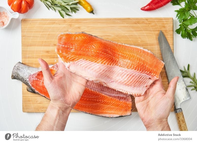 Process of butchering of fresh fish cooking process seafood raw salmon cutting knife chef ingredient herb spices peppers season table cuisine restaurant kitchen