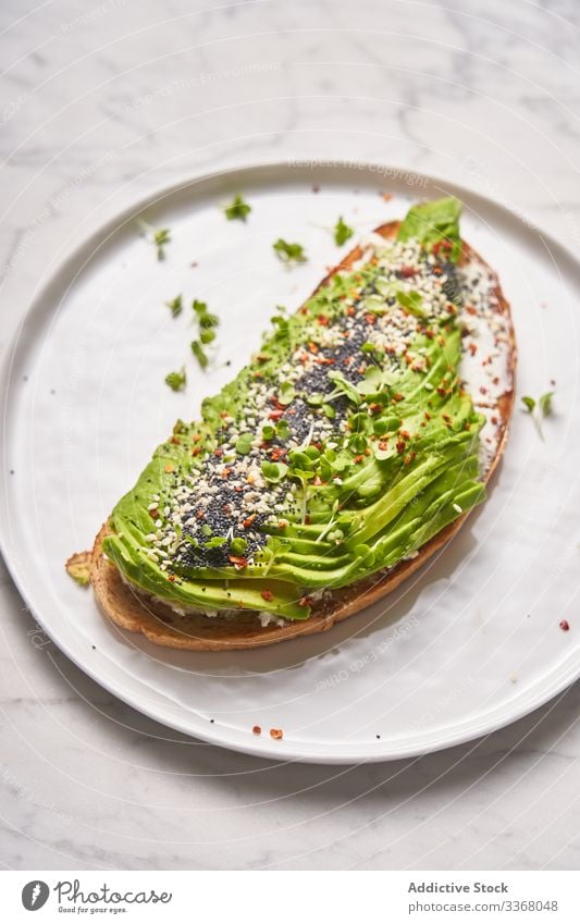 Perfect open sandwich with avocado spice bread plate dish fork style restaurant healthy organic natural tableware slice herb cream sauce stylish elegant