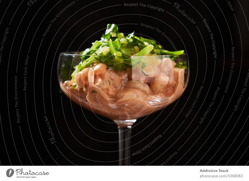 Shrimp cocktail in stylish glass shrimps prawn seafood sour glass modern sauce fried herb green snack fresh delicious healthy appetizer cuisine meal dish cooked