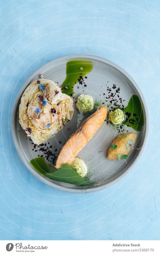 High cuisine dish of seafood salmon restaurant pike caviar cabbage sauce high cuisine haute cuisine plate served decoration fish dinner gourmet fresh fillet