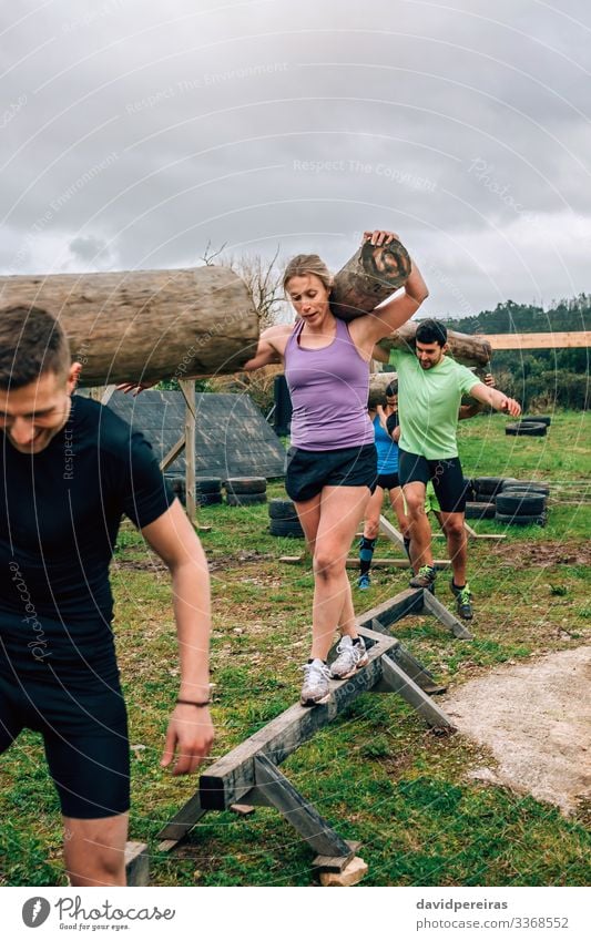 Participants in obstacle course carrying trunks Contentment Sports Human being Woman Adults Man Group Smiling Carrying Authentic Strong Power Effort Competition