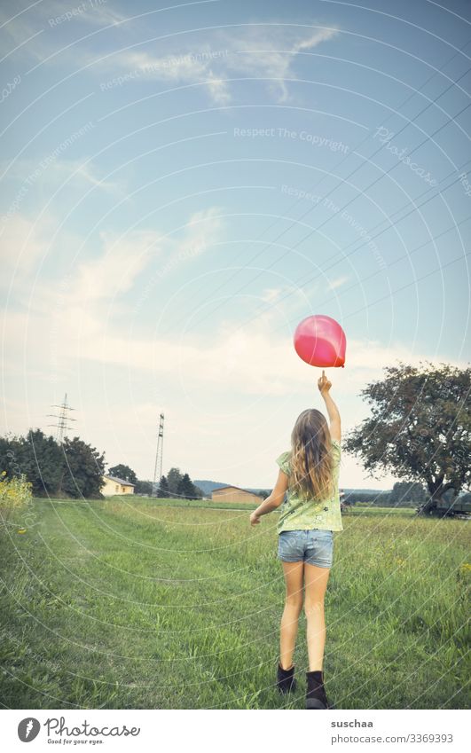 touch as a flight aid | lifted off Child Girl Infancy Summer Exterior shot Landscape Field Meadow Village Hair and hairstyles Balloon Tree Shorts Rear view