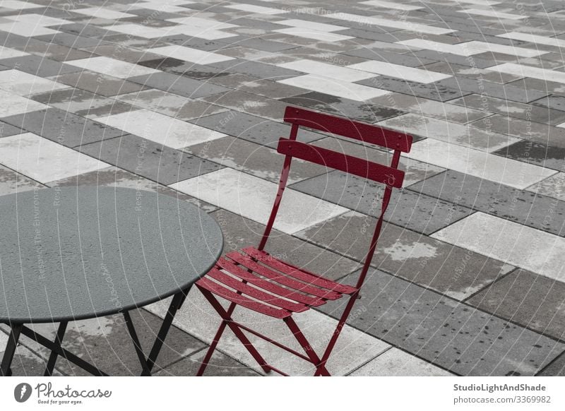 Outdoor cafe with red chair and table Furniture Chair Table Rain Town Street Stone Metal Drop Dark Simple Wet Gray Red Café Cafeteria bistro exterior Europe