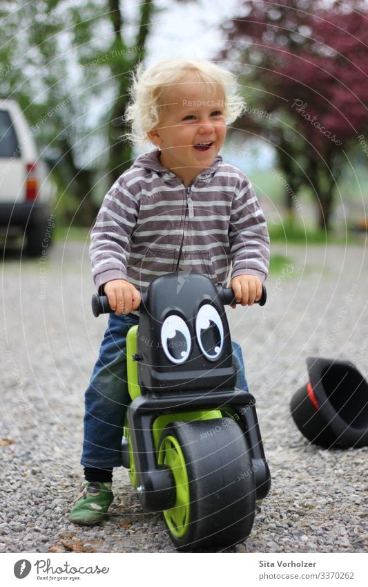 Laughing boy on wheel Leisure and hobbies Summer Cycling Bicycle Parenting Child Human being Masculine Toddler Boy (child) Infancy 1 1 - 3 years Spring Park Hat