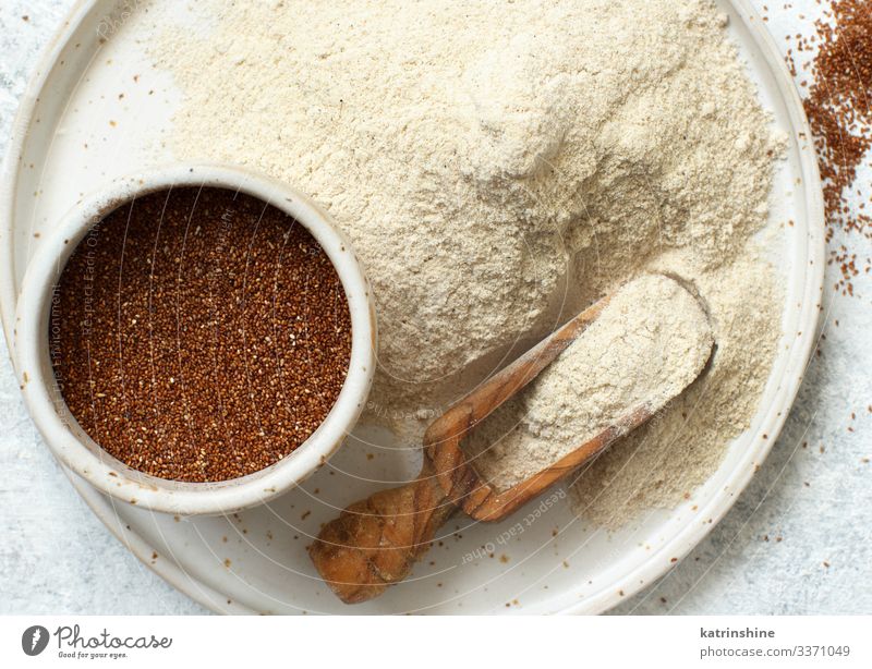 Teff flour and teff grain with a spoon Vegetarian diet Diet Plate Spoon Wood Above Flour food african gluten free preudocereal ceramic Cooking healthy Heap
