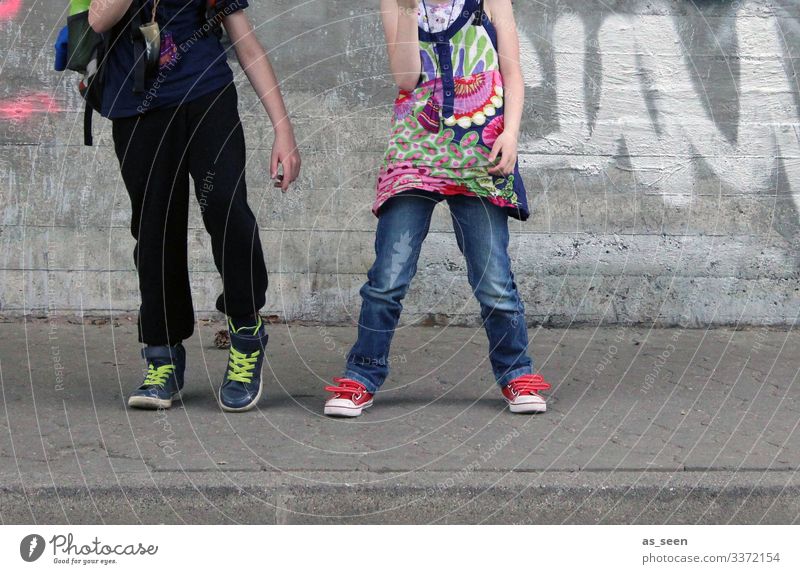 Dancin' in the street Girl Boy (child) 2 Human being Youth culture Subculture Environment Town Sidewalk Wall (barrier) Wall (building) Facade Street T-shirt
