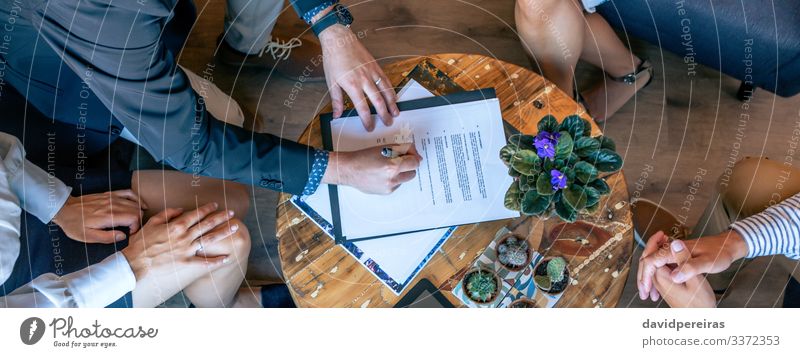 Top view of man signing a document Work and employment Office Business Company Internet Human being Woman Adults Man Hand Group Plant Cactus Aircraft Teamwork