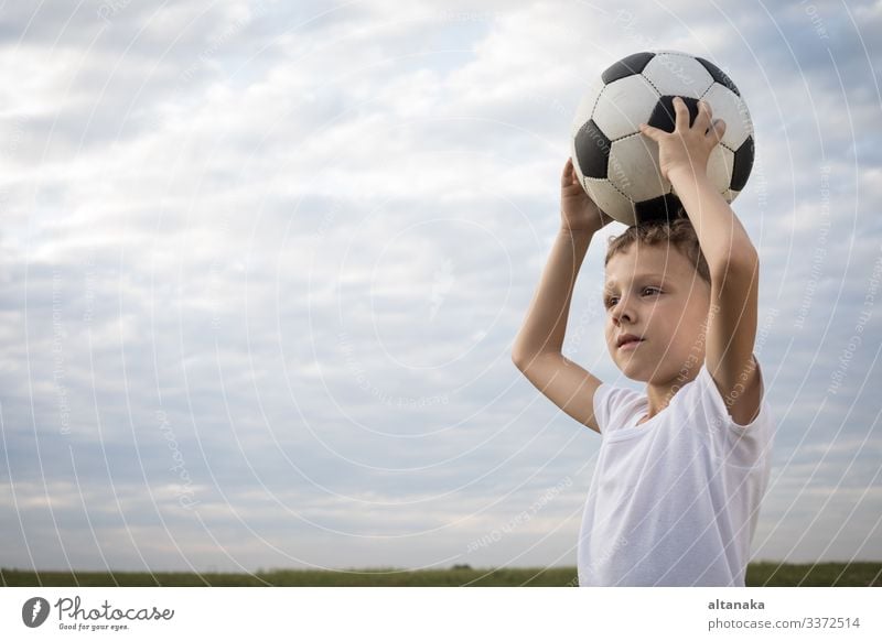 Portrait of a young boy with soccer ball. Concept of sport. Lifestyle Joy Happy Relaxation Leisure and hobbies Playing Summer Sports Soccer Child Human being
