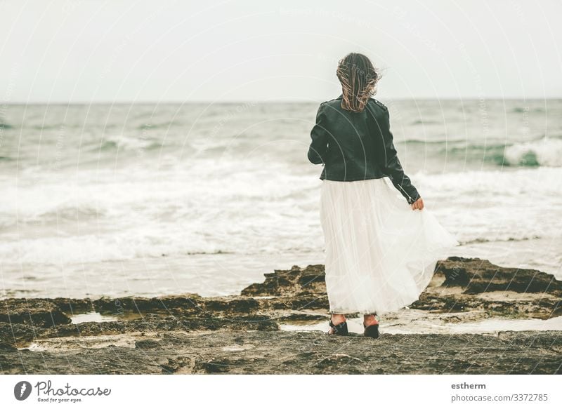 Back view of Pensive Young woman on the beach Lifestyle Elegant Style Beautiful Wellness Vacation & Travel Freedom Summer Beach Ocean Waves Human being Feminine
