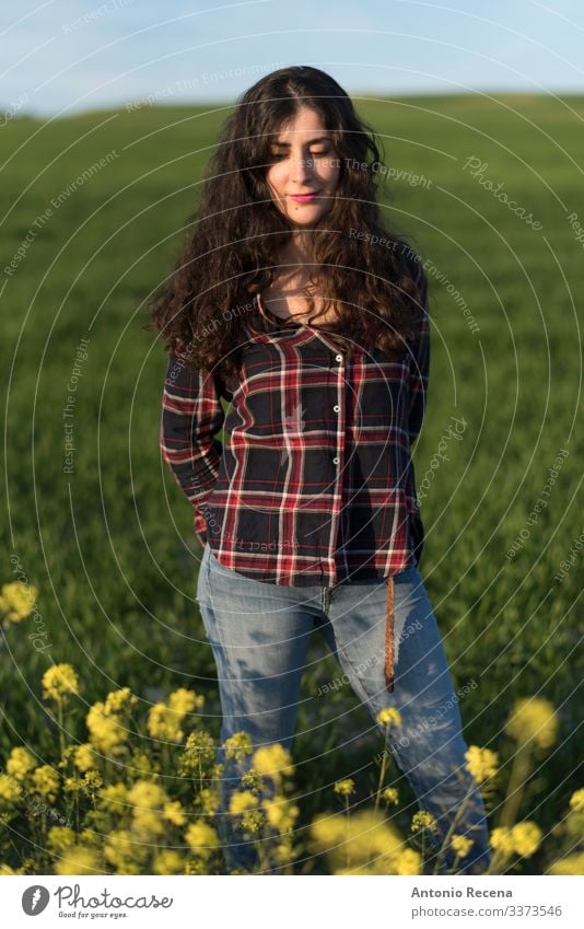 Pretty woman in spring portrait Lifestyle Human being Woman Adults Flower Meadow Shirt Jeans Long-haired Stand spanish Sunset plaid shirt people 1 Person 40s