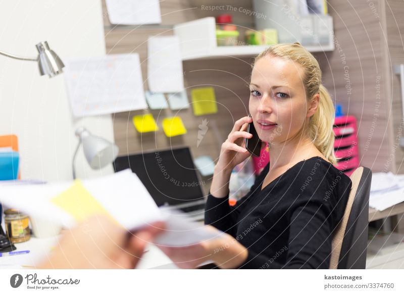 Business woman talking on mobile phone accepting papers. Happy Desk Table Work and employment Profession Office work Workplace Company To talk Telephone