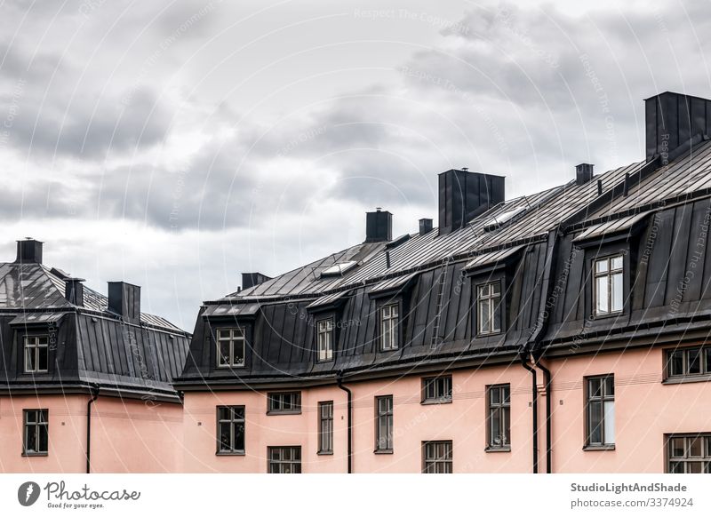 Pastel colored buildings with black roofs house houses windows rooftop Europe European Stockholm Sweden Swedish Scandinavia Scandinavian attic urban city town