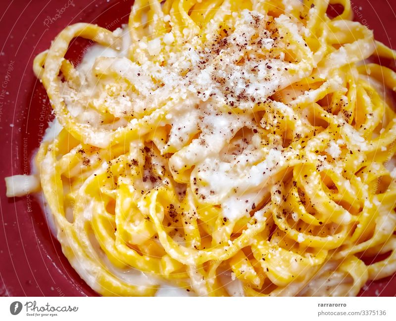 A portion of Italian traditional pasta with cacio e pepe Cheese Nutrition Lunch Dinner Diet Italian Food Plate Bowl Fork Kitchen Restaurant Fresh Hot Delicious