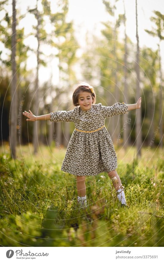 Little girl in nature field wearing beautiful dress little child happy children spring outside summer meadow playing portrait outdoor fashion happiness baby