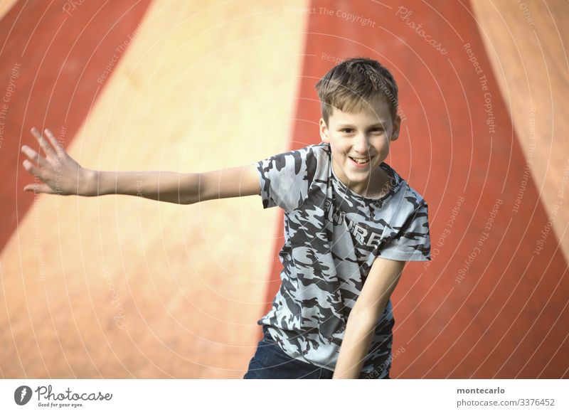 Young boy has fun on a bouncy castle Exterior shot Child Portrait photograph Pride Boy (child) Colour photo Day Moody Thin Looking 8 - 13 years Human being