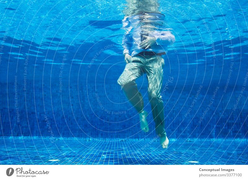 Low angle of businessman underwater Man Adults Legs 1 Human being Turquoise Businessman Head above water Low angle view Midsection Out of context Struggle