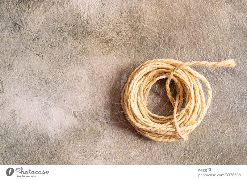 View of a roll of rope on a golden background Decoration Tool Curl Sphere Old Simple Idea backdrop Biodegradable Bobbin border braided cable cabling coil