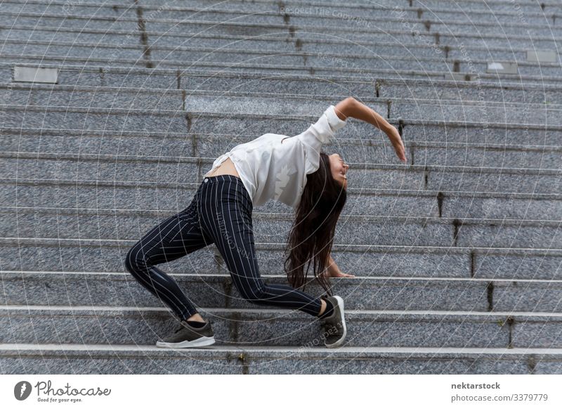 Young Woman Doing Back Stand on Marble Steps handstand dance female girl woman young adult youth culture day casual staircase steps outdoor 1 person balance