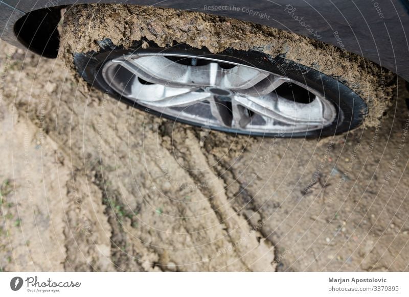 Close-up of a muddy tire on a car accident auto automobile autumn closeup concept country danger dangerous dirt dirty drive ground land off road outdoor