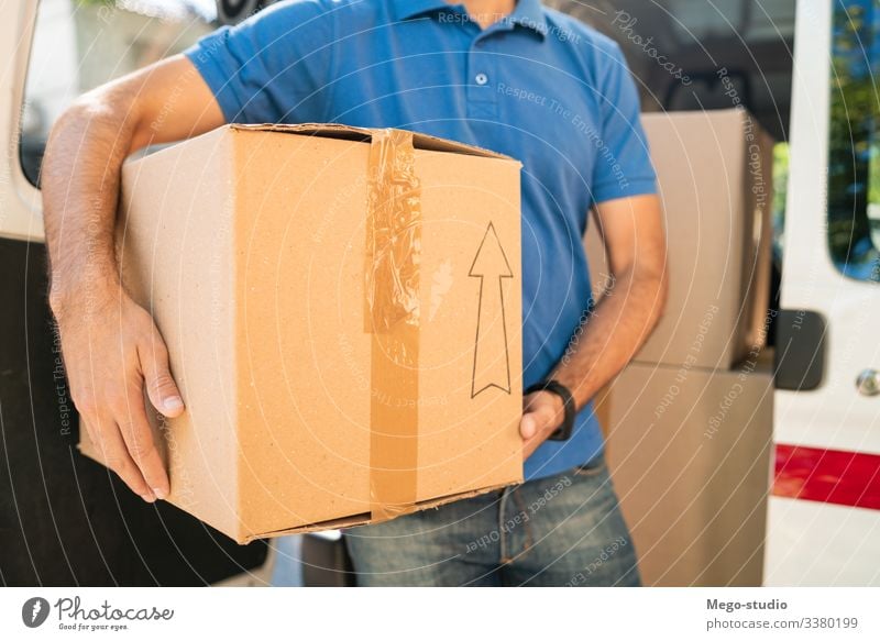 Delivery man unloading cardboard boxes from van. male service package delivery shipping industry work send office closeup logistic consumer carrying profession