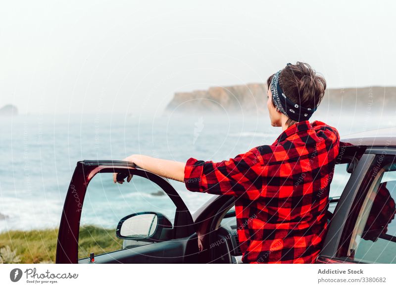 Female teenager in casual wear at lonely seashore woman extraordinary travel view seaside shirt rebel female hipster car transport trip journey nature vehicle