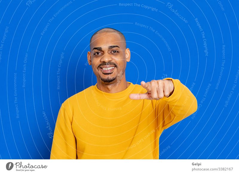 African guy with a yellow jersey black blue hand you pointing accuse laugh indicate selecting selection finger adult people person african male american man