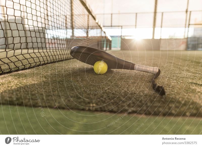 Paddle tennis image of court, racket, net and ball padel paddle tennis sport paddle-tennis pádel sunset tennis ball outdoors objects no people nobody fences