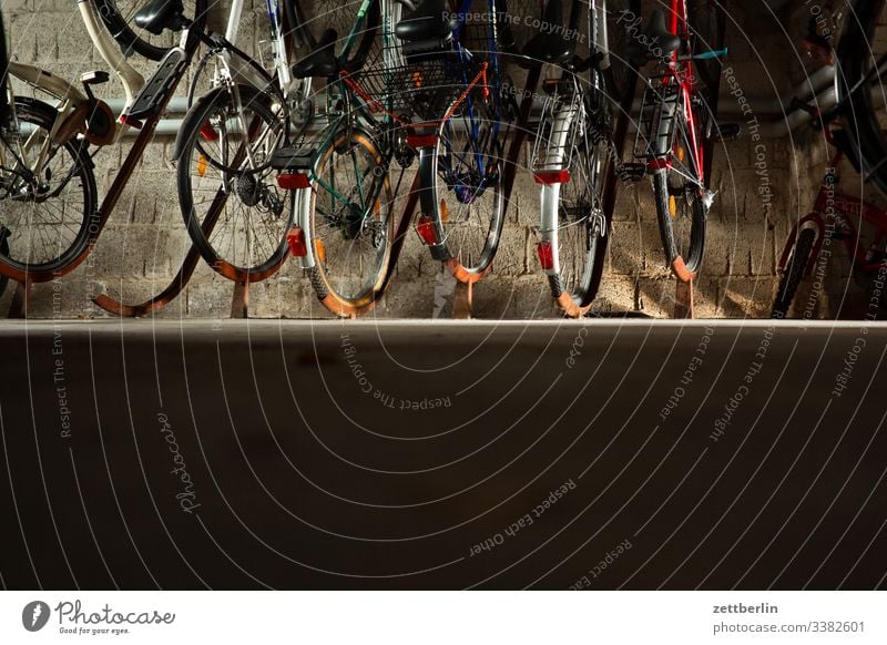 Bicycles in the bicycle cellar parking facility Parking area Dark ground floor Bicycle rack inboard Cellar Deserted Wheel Copy Space urban dwell