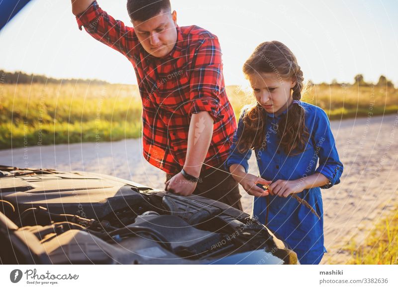 father and daughter fixing problems with car during summer road trip. Kid helping dad. child family girl mechanic repair automobile man outdoors vehicle parent