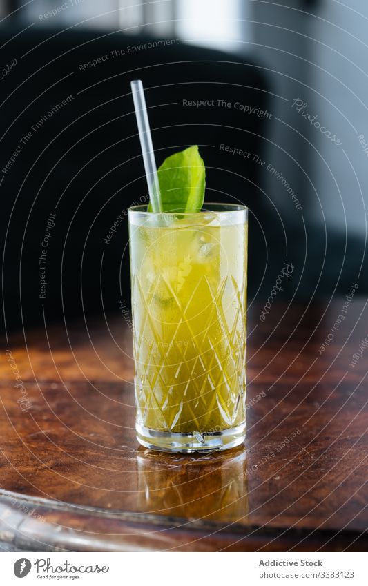 Fresh lemonade decorated with green on table glass drink mint straw beverage fruit fresh cold juice refreshment cool tasty delicious bar liquid citrus exotic